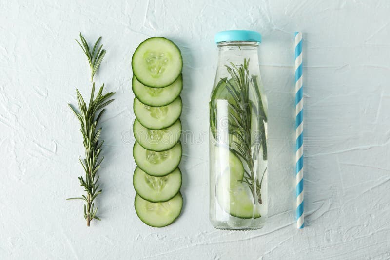 Composition with cucumber water and slices on background, top view. Composition with cucumber water and slices on white background, top view stock photography