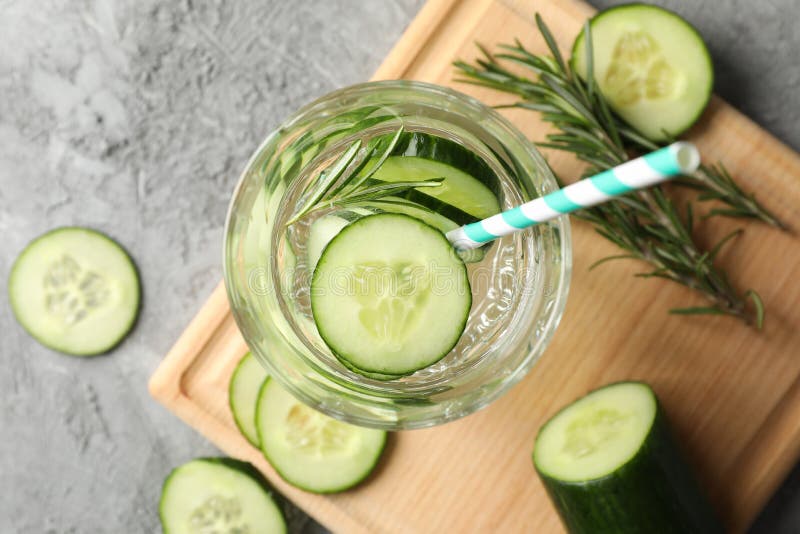 Composition with glass of cucumber water on background, top view. Composition with glass of cucumber water on grey background, top view royalty free stock images