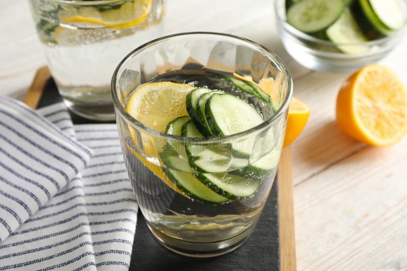 Composition with glasses of cucumber water on background, close up. Composition with glasses of cucumber water on wooden background, close up stock photos