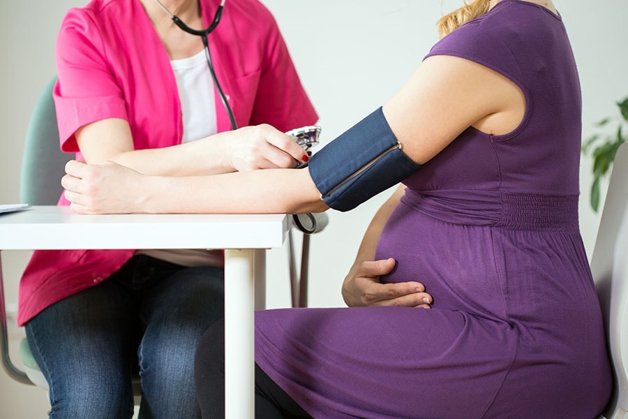 A doctor measuring a pregnant woman