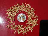 Textured vegetable protein (TVP) flakes and the quarter coin. TVP must be rehydrated with water/liquid before use.